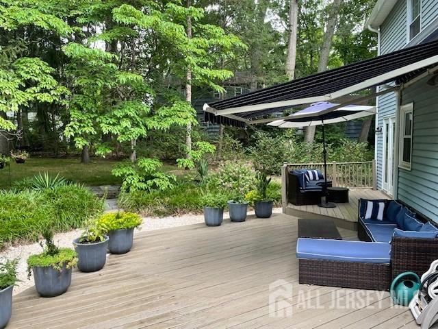 17 SE Candle Ln, East Brunswick, NJ 08816 - wooden terrace featuring an outdoor hangout area