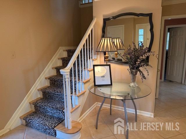 17 SE Candle Ln, East Brunswick, NJ 08816 - stairs with baseboards and tile patterned floors