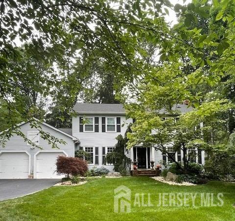 17 SE Candle Ln, East Brunswick, NJ 08816 - view of front of home featuring an attached garage, aphalt driveway, and a front yard