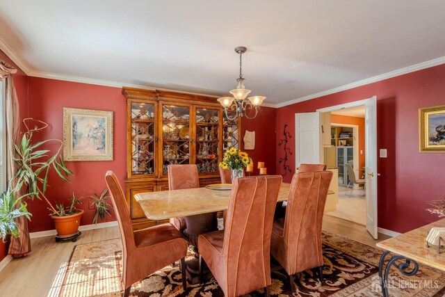 17 SE Candle Ln, East Brunswick, NJ 08816 - dining room with a chandelier, wood finished floors, ornamental molding, and baseboards