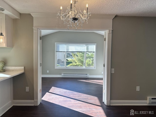 unfurnished dining area with a baseboard heating unit, an inviting chandelier, wood finished floors, and a textured ceiling