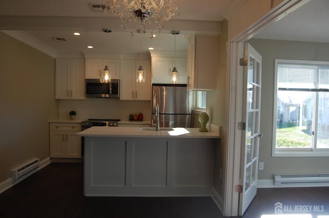 kitchen featuring visible vents, appliances with stainless steel finishes, a peninsula, white cabinetry, and a baseboard radiator