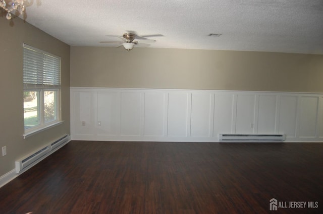 unfurnished room featuring a baseboard radiator, dark wood-type flooring, baseboard heating, and a ceiling fan