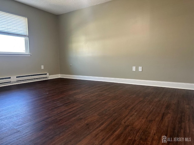 unfurnished room with a baseboard radiator, baseboards, dark wood-style flooring, and a textured ceiling