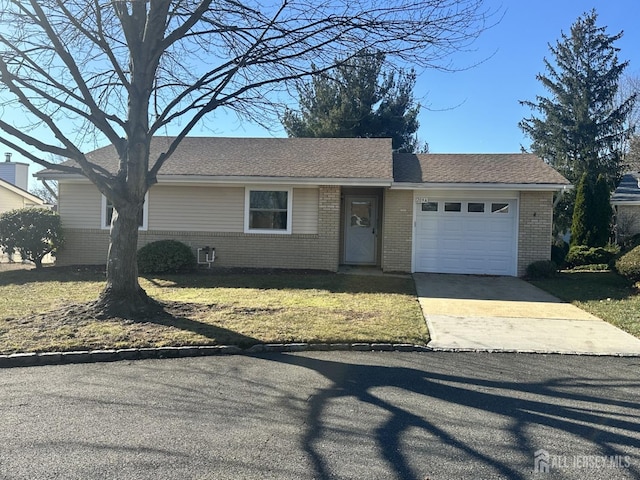 single story home with a garage and a front yard