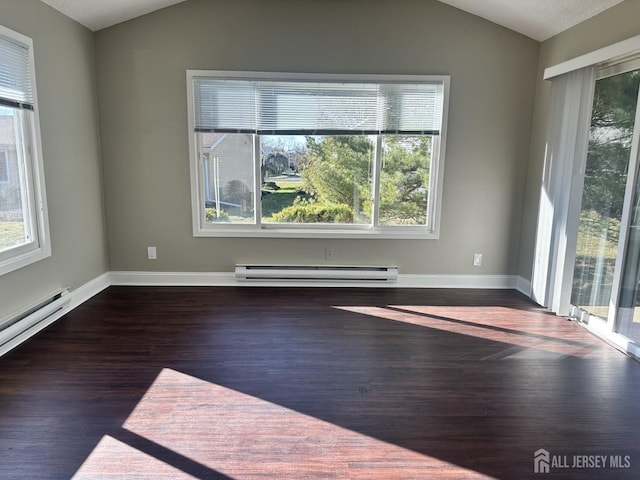 empty room with vaulted ceiling, wood finished floors, baseboards, and a baseboard radiator