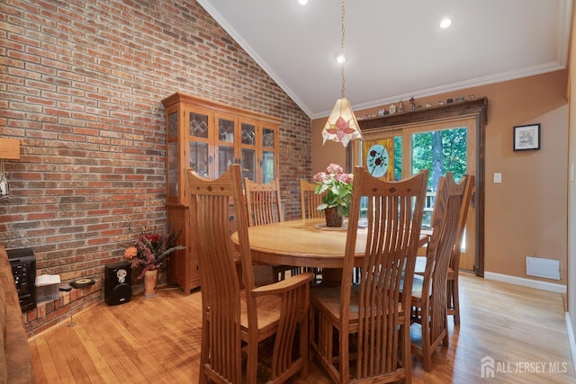 2 Kerry Ct, Old Bridge, NJ 08857 - dining space with lofted ceiling, light wood-style floors, brick wall, and ornamental molding
