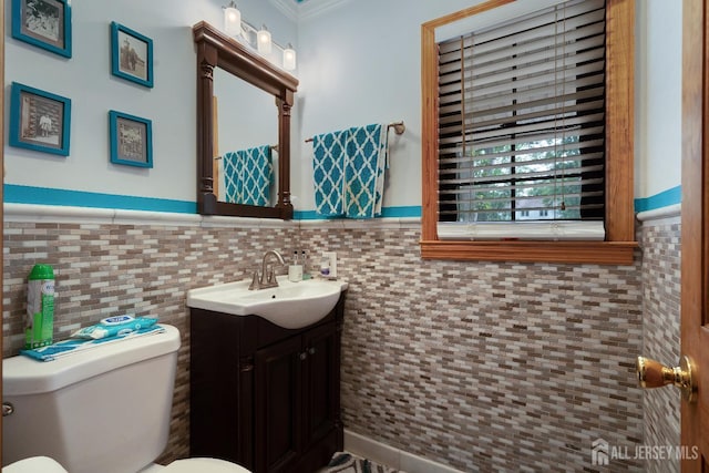 2 Kerry Ct, Old Bridge, NJ 08857 - bathroom with vanity, tile walls, ornamental molding, and a wainscoted wall