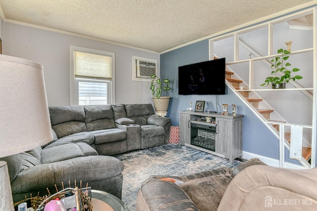 living area featuring crown molding, a textured ceiling, a wall mounted air conditioner, and stairs