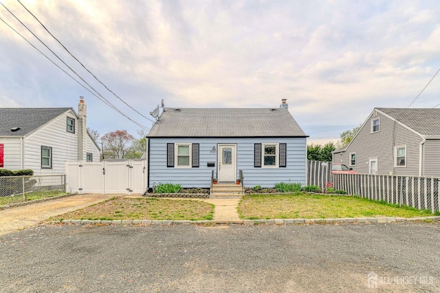view of front of property with a gate