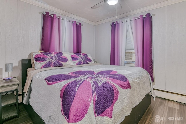 bedroom with wood finished floors, a baseboard radiator, ornamental molding, a ceiling fan, and wood walls