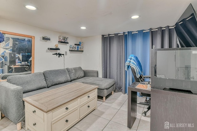 living area featuring light tile patterned floors and recessed lighting