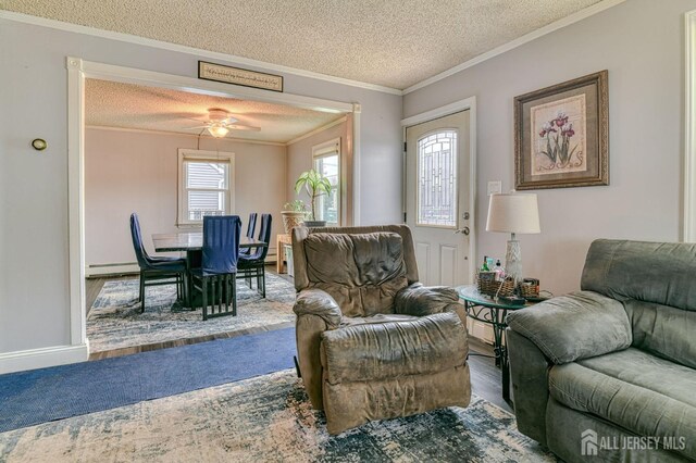 9 Macarthur Ave, Spotswood, NJ 08884 - living room with a textured ceiling, wood finished floors, ornamental molding, ceiling fan, and a baseboard heating unit