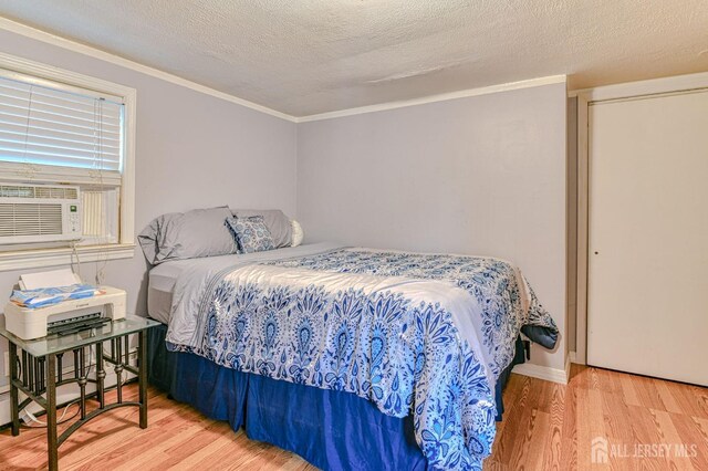 9 Macarthur Ave, Spotswood, NJ 08884 - bedroom featuring wood finished floors, cooling unit, crown molding, and a textured ceiling