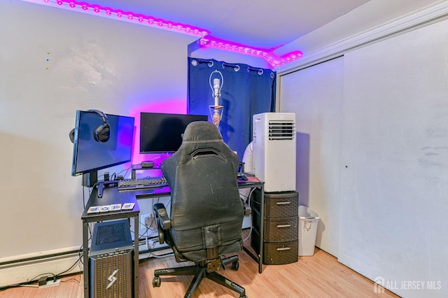 office featuring wood finished floors and a baseboard radiator