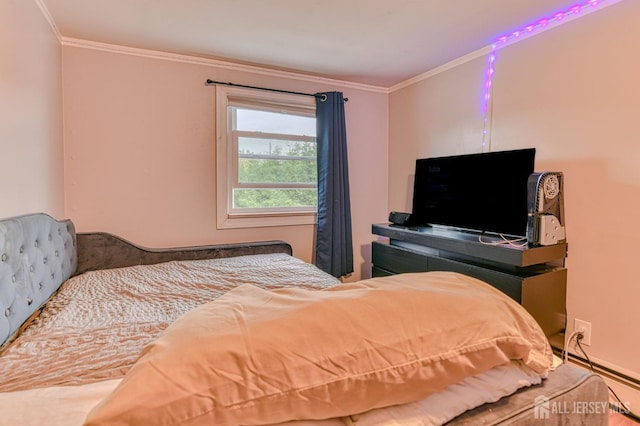 bedroom with ornamental molding and baseboard heating