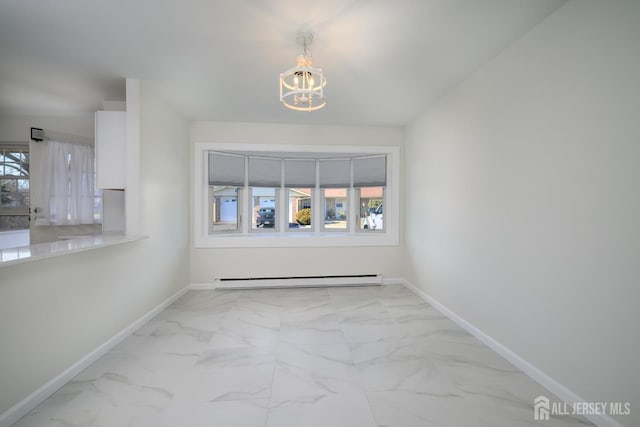 spare room with a baseboard heating unit, an inviting chandelier, baseboards, and marble finish floor