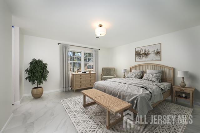 bedroom featuring baseboards and marble finish floor