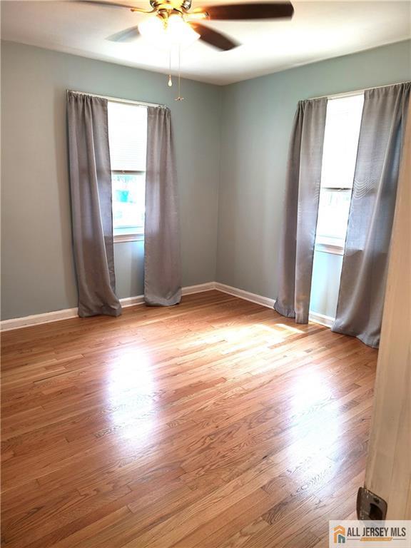 318 Hoover Ave, Edison, NJ 08837 - empty room with a ceiling fan and wood finished floors