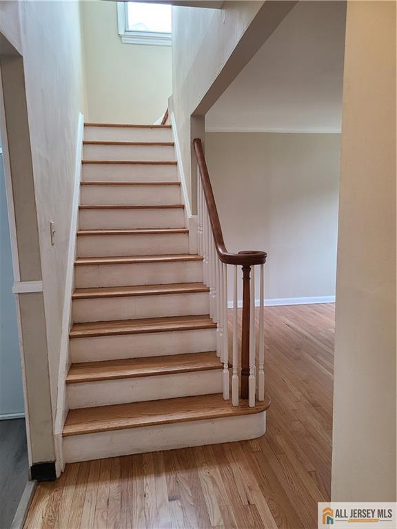 318 Hoover Ave, Edison, NJ 08837 - stairway featuring wood finished floors and baseboards