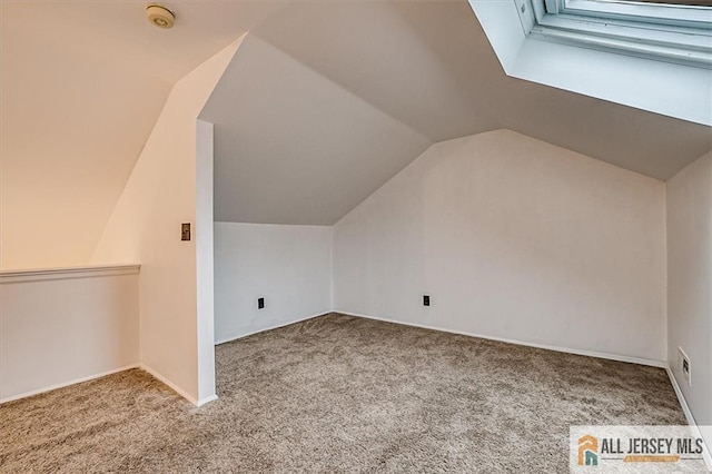 additional living space with carpet floors and lofted ceiling
