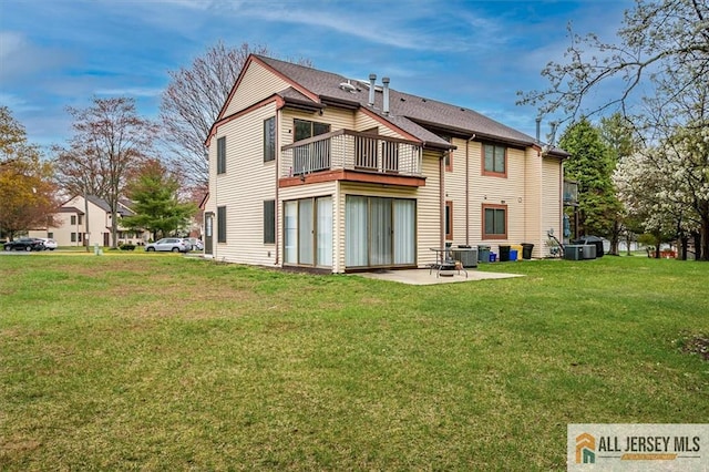 back of property featuring a lawn, central AC unit, a balcony, and a patio area