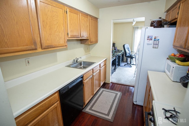 kitchen with dark hardwood / wood-style flooring, sink, and white appliances