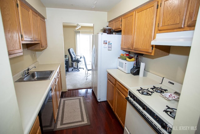 kitchen with sink, white appliances, and dark wood-type flooring