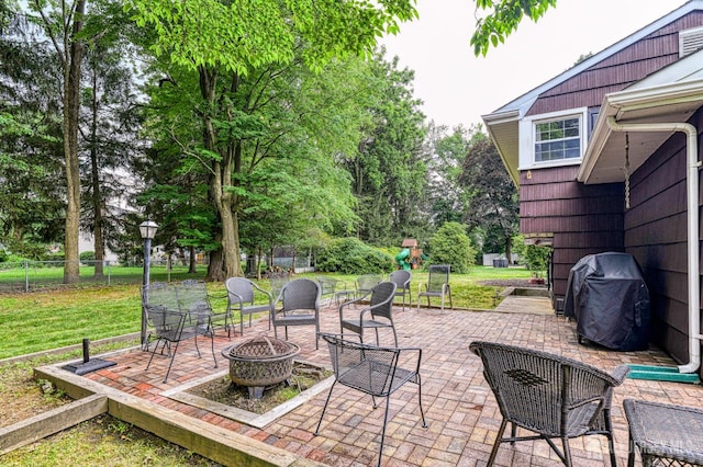 1056 Kearney Dr, North Brunswick, NJ 08902 - view of patio featuring an outdoor fire pit, a grill, and view of scattered trees