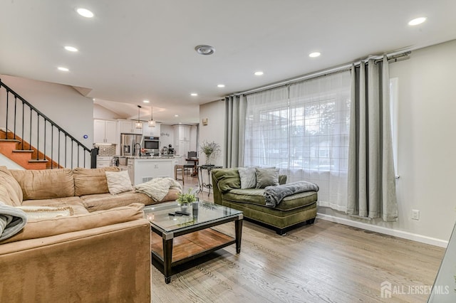1056 Kearney Dr, North Brunswick, NJ 08902 - living room featuring light wood-style floors, recessed lighting, and stairs