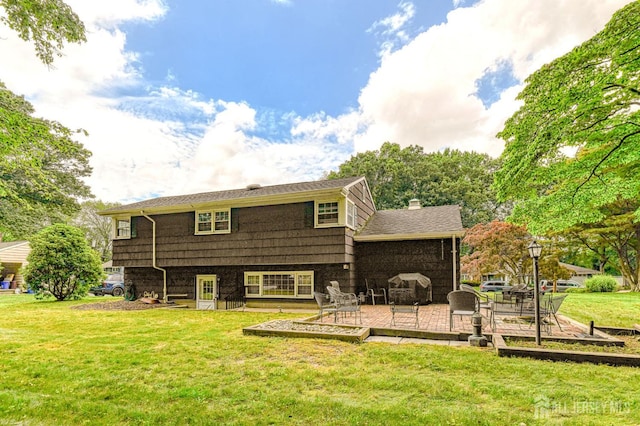 1056 Kearney Dr, North Brunswick, NJ 08902 - back of property with a yard, a chimney, and a patio area