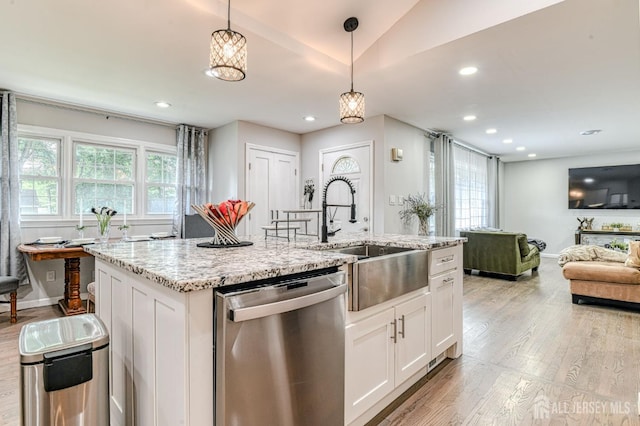 1056 Kearney Dr, North Brunswick, NJ 08902 - kitchen featuring stainless steel dishwasher, light wood-style flooring, light stone countertops, pendant lighting, and white cabinetry
