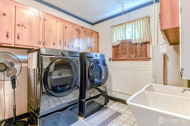 1056 Kearney Dr, North Brunswick, NJ 08902 - laundry area featuring washing machine and dryer, cabinet space, light tile patterned floors, and concrete block wall