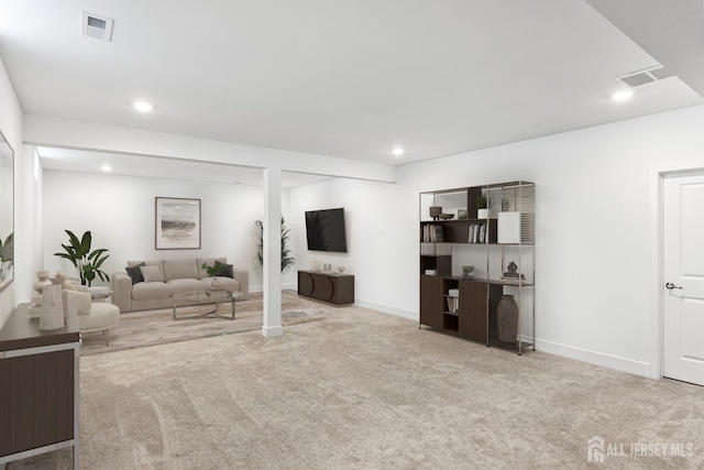 carpeted living area with visible vents, recessed lighting, and baseboards