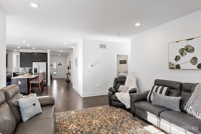 living area with recessed lighting, baseboards, visible vents, and dark wood-style floors