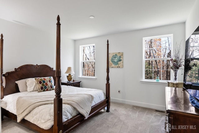 carpeted bedroom featuring baseboards and visible vents