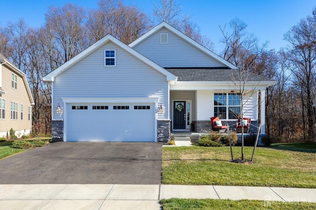 craftsman inspired home featuring a shingled roof, a front lawn, stone siding, a garage, and driveway