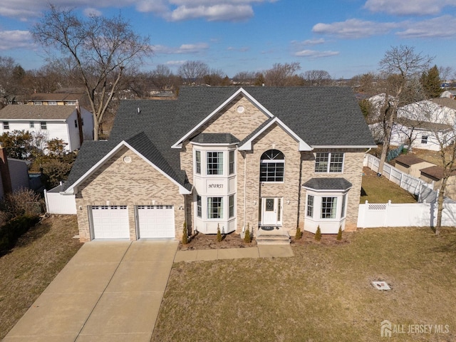 view of front of house with a garage and a front lawn