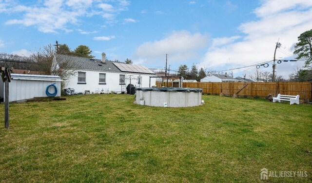 view of yard featuring a covered pool