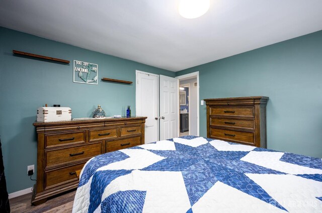 bedroom with dark wood-type flooring