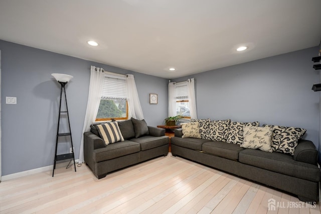 living room with light wood-type flooring, baseboards, and recessed lighting