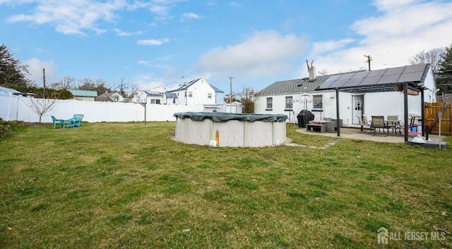 view of yard with a covered pool and a patio