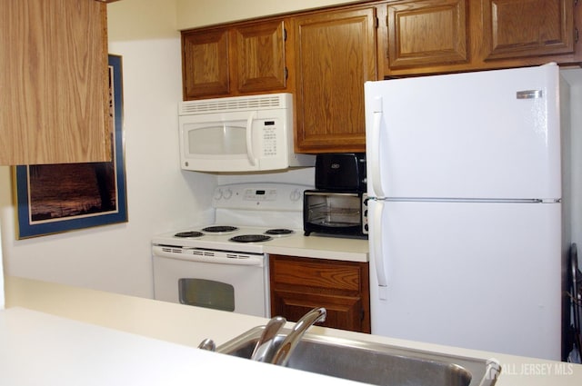 422 Ravens Crest Dr, Plainsboro, NJ 08536 - kitchen featuring white appliances, a sink, light countertops, and brown cabinets