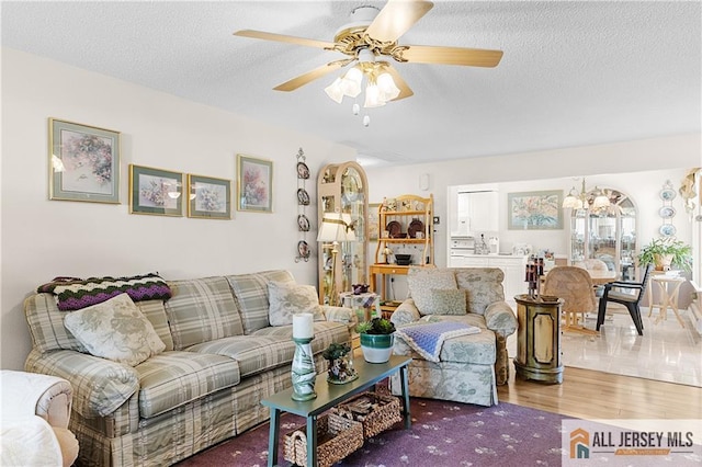 180 Mimosa Plz Unit 180A, Monroe, NJ 08831 - living room with wood finished floors, a chandelier, ceiling fan, and a textured ceiling