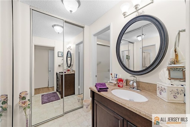 180 Mimosa Plz Unit 180A, Monroe, NJ 08831 - bathroom with vanity and a textured ceiling