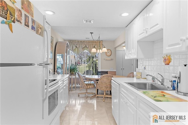 180 Mimosa Plz Unit 180A, Monroe, NJ 08831 - kitchen with white appliances, a sink, white cabinetry, backsplash, and light countertops