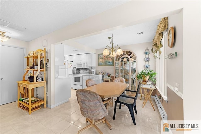 180 Mimosa Plz Unit 180A, Monroe, NJ 08831 - dining space with a chandelier, light tile patterned floors, a baseboard heating unit, and a textured ceiling