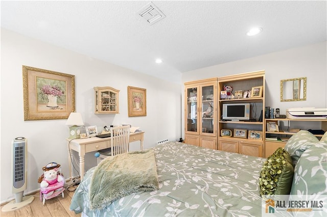 180 Mimosa Plz Unit 180A, Monroe, NJ 08831 - bedroom with wood finished floors, recessed lighting, baseboards, and a textured ceiling