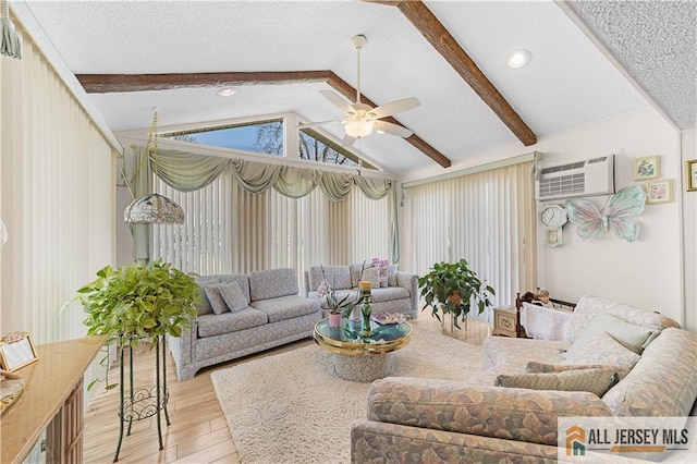 180 Mimosa Plz Unit 180A, Monroe, NJ 08831 - living room with wood finished floors, a wall mounted air conditioner, a ceiling fan, and a textured ceiling