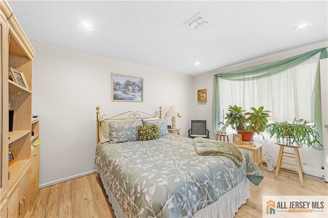 180 Mimosa Plz Unit 180A, Monroe, NJ 08831 - bedroom featuring light wood-style floors, recessed lighting, and a textured ceiling